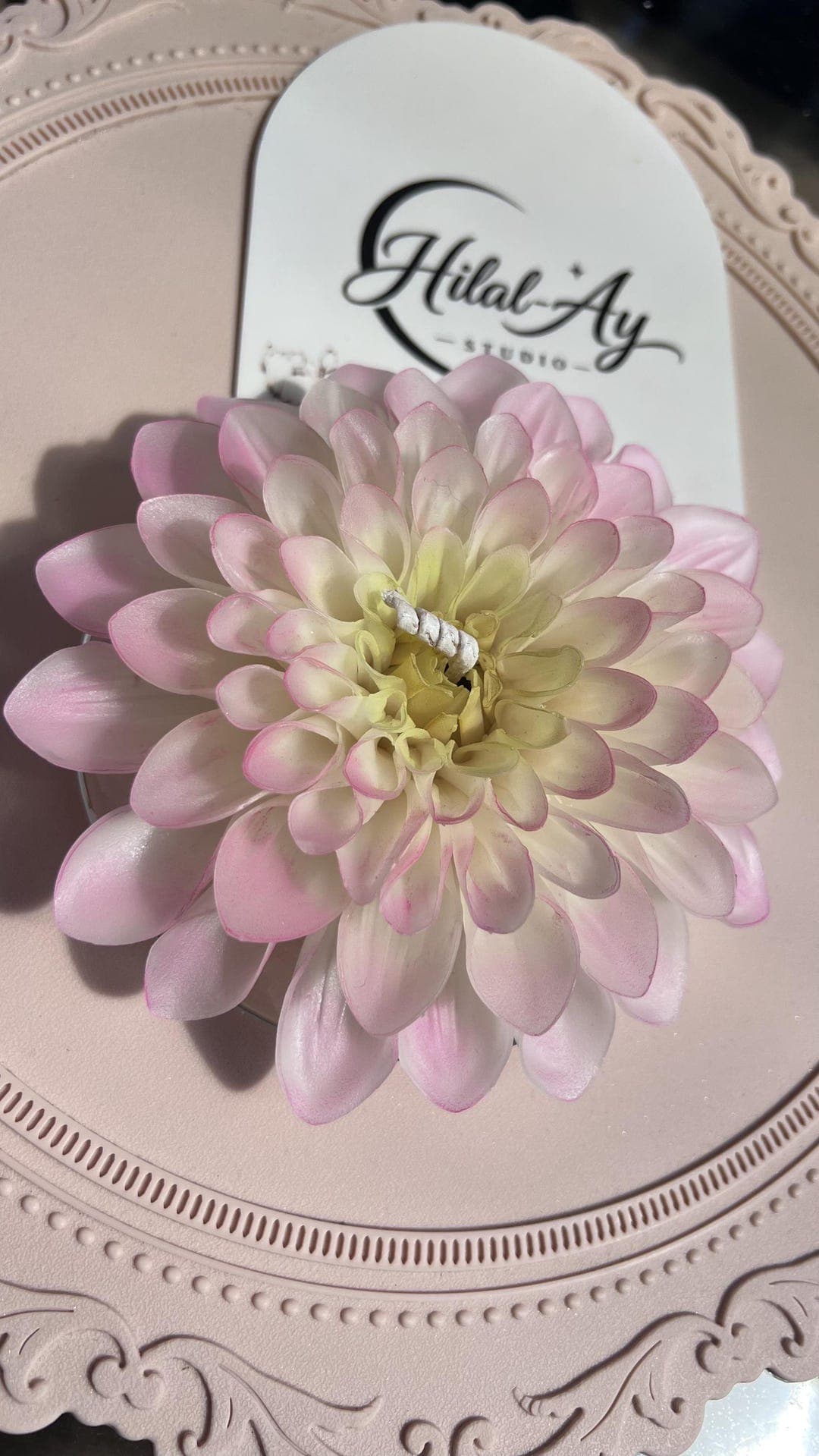 Close view of the hand-sculpted petals of the blush dahlia candle